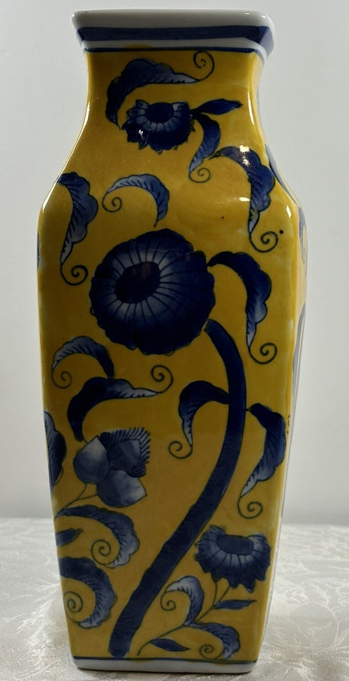 Blue floral painting detail on yellow glaze