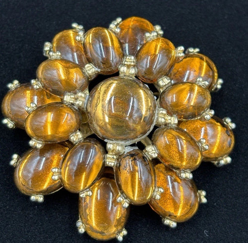 Tiger eye look glass stone close-up on huge 1950s brooch